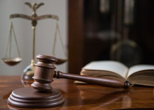 Sixth Circuit Invalidates Contractual Limitations Period for Title VII Claims - photo of gavel and scales of justice